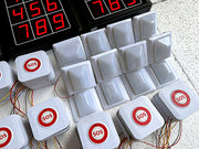 White buttons with red 'SOS' labels and a digital display on a textured surface.