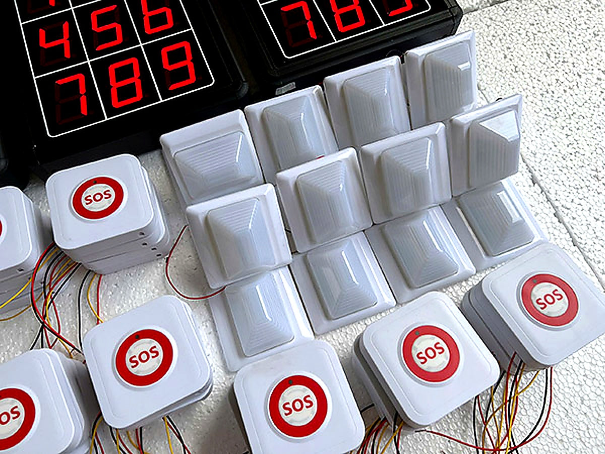 White buttons with red 'SOS' labels and a digital display on a textured surface.