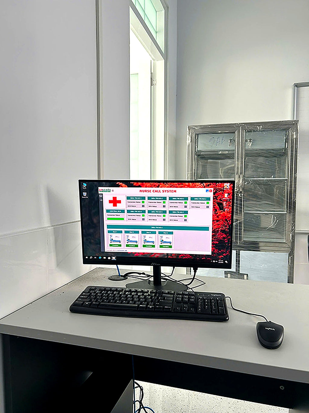 Computer monitor displaying a software interface on a desk with a window in the background.