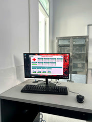 Computer monitor displaying a software interface on a desk with a window in the background.