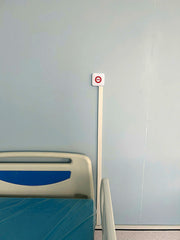 Bed with blue mattress against a light gray wall