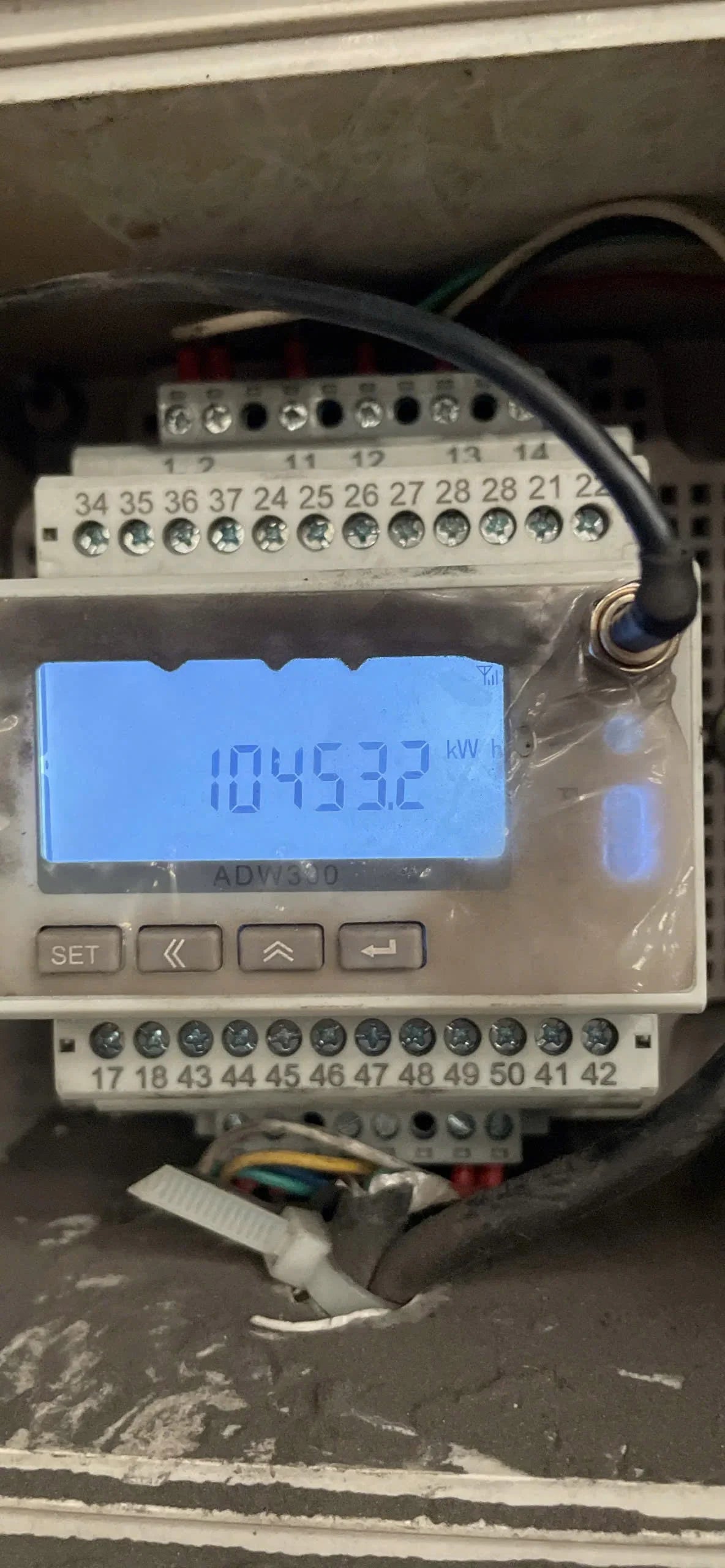 Digital display with a blue screen showing numbers on a metallic surface.