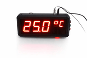 Digital thermometer with red LED display on a white background