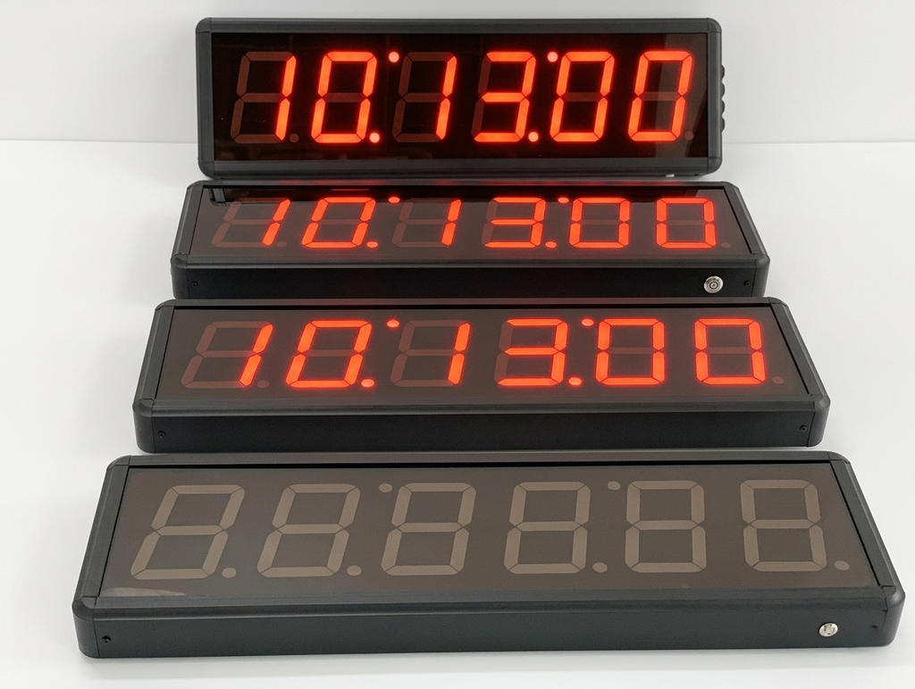 Set of digital timers with red and gray LED display on a white background