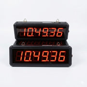 Digital clock with red LED display on a white background