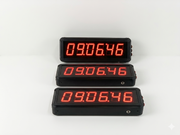 Three digital displays with red LED numbers on a white background