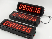 Three digital displays with red LED numbers on a white background