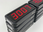 Stack of digital display modules with red LED numbers on a white background