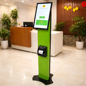 A sleek green self-service kiosk with a touchscreen and printer in a bright office lobby, used for administrative queue management.