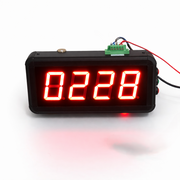 Digital clock with red LED display on a white background