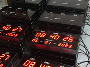 Stack of digital clocks displaying time and date information.