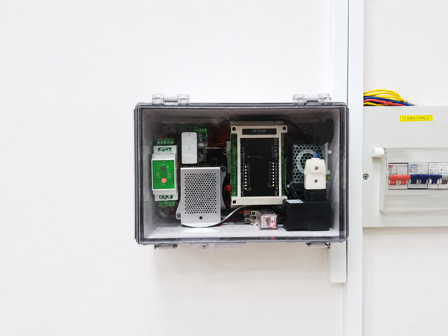 Electrical panel with various components inside a metallic box on a white background