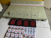 Control panels with digital displays and dice on a concrete floor.